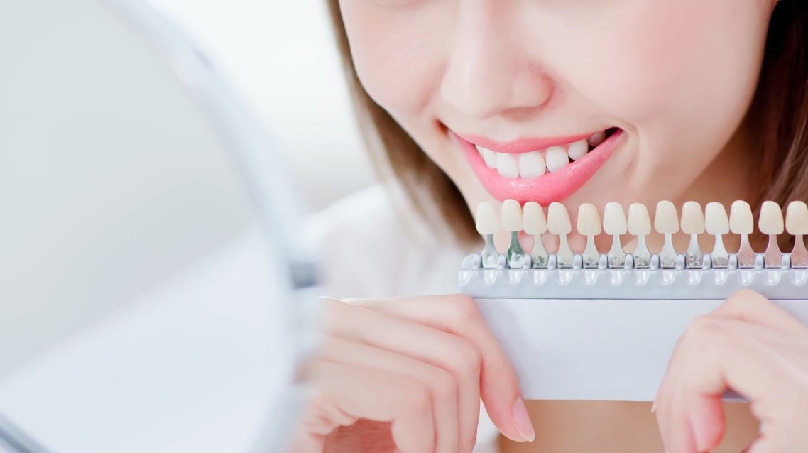 A girl getting her teeth whitened at the dentist